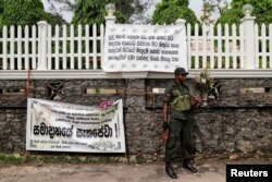 FILE- A soldier stands guard outside St. Sebastian Church, days after a string of suicide bomb attacks across the island on Easter Sunday, in Negombo, Sri Lanka, May 1, 2019.