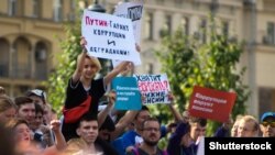 RUSSIA – Protests against pension reform a young girl is holding a sign saying "Putin Warrants Corruption and Degradation" during protests in Moscow, September 9, 2018