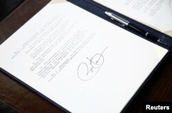 U.S. President Barack Obama's signature is seen on a set of executive orders that he signed prior to unveiling a series of proposals to counter gun violence, at the White House in Washington, January 16, 2013.