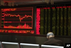FILE - A Chinese man naps at a brokerage in Beijing, China, Dec. 25, 2018.