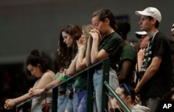 Students observer a moment of silence during a vigil at the University of North Carolina-Charlotte in Charlotte, N.C., May 1, 2019 after a student with a pistol killed two people and wounded four others on Tuesday.