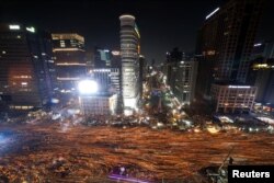 FILE - People march toward the Presidential Blue House during a protest calling for South Korean President Park Geun-hye to step down in central Seoul, South Korea, Dec. 3, 2016.