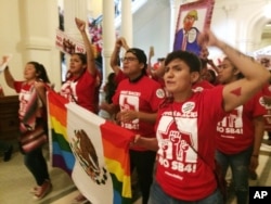 FILE - Demonstrators in the Texas Capitol protest the state's newly passed anti-sanctuary cities bill, in Austin, Texas, May 29, 2017.