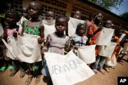 Children wait for the arrival of Pope Francis at a refugee camp, in Bangui, Central African Republic, Nov. 29, 2015.