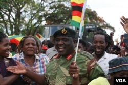 Strange bed fellows ... A senior army official on the streets with members of the public ...