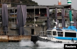 FILE - A Turkish coast guard boat patrols in front of the Reina nightclub by the Bosphorus, which was attacked by a gunman, in Istanbul, Jan. 1, 2017.