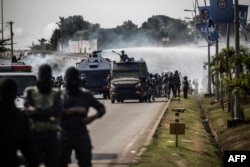 A riot police water cannon is seen spraying supporters of Gabonese opposition leader Jean Ping during clashes in Libreville on Aug. 31, 2016, as part of a protest sparked after Gabon's president Ali Bongo was declared winner.