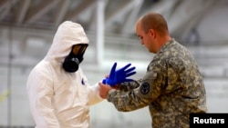 The U.S. sent about 3,000 soldiers to fight Ebola. Here James Knight of U.S. Army Medical Research Institute of Infectious Diseases (USAMRIID) trains U.S. Army soldiers from the 101st Airborne Division (Air Assault) before their deployment to West Africa.