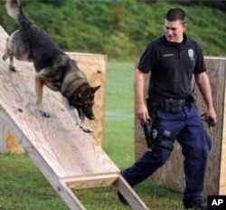 In this undated photo released by the Hattiesburg Police Department, Officer Benjamin Deen participates in K-9 training at the police academy in Hattiesburg, Miss.