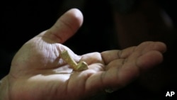Filipino archeologist Armand Salvador Mijares shows a Metatarsal bone, one of the oldest they recovered from Callao Cave belonging to a new specie they called Homo luzonensis, during a press conference in metropolitan Manila, Philippines.