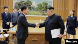 FILE - North Korean leader Kim Jong Un shakes hands with Chung Eui-yong, who led a special delegation of South Korea's president, in this photo released by North Korea's Korean Central News Agency, March 6, 2018.