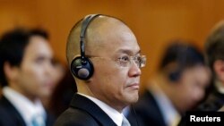 Thailand's Ambassador to the Netherlands Virachai Plasai listens as Judge Hisashi Owada reads the judgement of the Preah Vihear temple dispute between Cambodia and Thailand