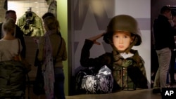 FILE - Customers visit the Russian Army store in downtown Moscow, Russia, July 21, 2015. The Russian Army Store opened earlier this year as an upmarket venue selling a wide range of patriotic goods.