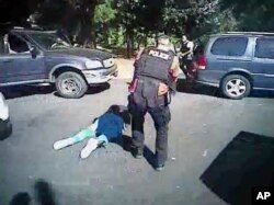 FILE - This image made from video provided by the Charlotte-Mecklenburg Police Department, Sept. 24, 2016, shows Keith Scott on the ground as police approach him in Charlotte, N.C., on Sept. 20, 2016.