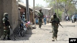 Nigerian soldiers are seen patrolling a town in Borno state, April 30, 2013.