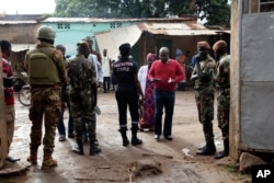Security men stand guard in front of a polling station during the Presidential elections in Bamako, Mali, July 29, 2018.