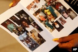 Alexis Willis holds the funeral program for her cousin Jaheim Wilson at her Chicago home, April 26, 2018. Wilson was shot and killed less than three weeks earlier as he walked with a friend in Chicago.