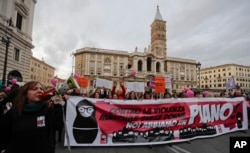 Women hold a banner reading in Italian, "Against the male violence on women we have a plan," as they take part in a march marking the International Day for the Elimination of Violence Against Women, in Rome, Nov. 25, 2017.