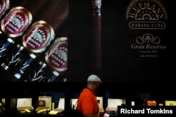 A visitor looks at cigars on display at the 19th Habanos Festival in Havana, Cuba, Feb. 27, 2017.