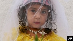 FILE - Three-year-old Sunam is dressed in a bridal outfit in Kabul, Afghanistan, Aug. 14, 2007.