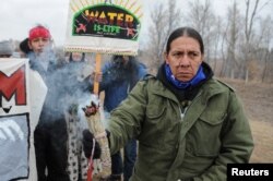 FILE - Protesters block highway 1806 in Mandan, North Dakota, during a protest against plans to pass the Dakota Access pipeline near the Standing Rock Indian Reservation, Nov. 23, 2016.