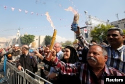 People light candles as they celebrate the arrival of the 'Holy Fire' from Jerusalem's Holy Sepulchre outside the Church of the Nativity in the West Bank town of Bethlehem, April 15, 2017.
