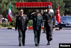 Turkish Chief of Staff General Hulusi Akar and his Iranian counterpart Major General Mohammad Baqeri review the guards of honor during a welcoming ceremony in Ankara, Turkey, Aug. 15, 2017.