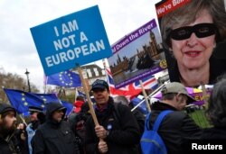 A pro-Brexit protester holds up a sign outside the Houses of Parliament in London, Britain, March 14, 2019.