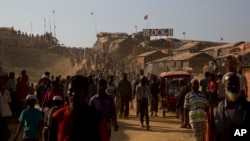 Rohingya refugees come out of their homes after the visit of Indonesian President Joko "Jokowi" Widodo at Jamtoli refugee camp near Cox's Bazar, Bangladesh, Jan. 28, 2018.