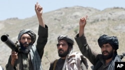 FILE - Taliban fighters react to a speech by their leader in the Shindand district of Herat province, Afghanistan, May 27, 2016. While Afghan officials and the U.S. military welcome Russian peace efforts, they are critical of Moscow’s contacts with the Taliban.