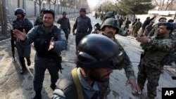 Security forces inspect the site of an Islamic State-claimed attack on a military hospital in Kabul, Afghanistan, March 8, 2017. "Don’t expect a terrorist to be taking on another terrorist,” says Afghanistan's National Security Adviser Haneef Atmar referring to Russia's alleged effort to turn the Taliban against Islamic State militants.