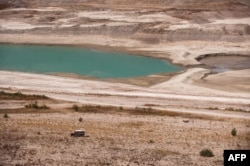 FILE - A partial view of Lar dam's reservoir at Damavand, 70 kilometers northeast of Tehran. Authorities warned Tehran residents to drastically reduce their water consumption, as three of the five dams supplying the capital are almost empty, Sept. 17, 201