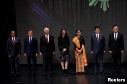 FILE - Japan's Prime Minister Shinzo Abe stands for photo with fellow Southeast Asian leaders at the 31st ASEAN Summit, in Manila, Philippines, Nov. 13, 2017.