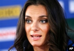 FILE - Russia's Yelena Isinbayeva, the gold medalist in the women's pole vault, speaks during a press conference at the World Athletics Championships in the Luzhniki stadium in Moscow, Russia, Aug. 15, 2013.