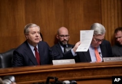 FILE - Sen. Lindsey Graham, R-S.C., left, chairman of the Judiciary subcommittee on crime and terrorism, and Sen. Sheldon Whitehouse, D-R.I., the panel's ranking Democrat.