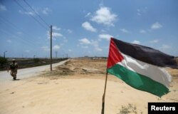 FILE - A member of Palestinian security forces loyal to Hamas patrols on border with Egypt, in Rafah in the southern of Gaza Strip, July 5, 2017.