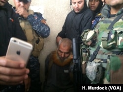 The day after capturing this Mosul neighborhood, Iraqi forces arrested this suspected militant after being informed of his whereabouts by civilian neighbors in Mosul, Mar. 2, 2017.