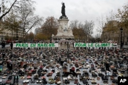 Hundreds of pairs of shoes are displayed at the place de la Republique, in Paris, as part of a symbolic and peaceful rally called by the NGO Avaaz "Paris sets off for climate", Nov. 29, 2015.