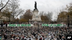 Hundreds of pairs of shoes are displayed at the place de la Republique, in Paris, as part of a symbolic and peaceful rally called by the NGO Avaaz "Paris sets off for climate", Nov. 29, 2015.