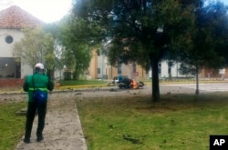 In this image provided by military personnel, flames rise from a deadly truck bombing at a police academy on Jan. 17, 2019, in Bogota, Colombia.