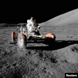NASA astronaut Gene Cernan drives the lunar rover on the moon during the Apollo 17 mission, Dec. 11, 1972.
