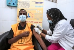 A medical worker receives a dose of the Oxford-AstraZeneca COVID-19 coronavirus vaccine at the Jabra Hospital for Emergency and Injuries in Sudan's capital Khartoum on March 9, 2021.