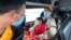 People wear masks on a bus in Quang Ninh province, Vietnam, Jan. 28, 2018. A tourism company director in Vietnam says the coronavirus outbreak that began in China has hit his industry “very hard, like a giant bomb."