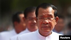 People gather to collect food aid in a flooded area following heavy monsoon rainfalls in Companiganj, Bangladesh.