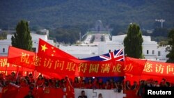 亲中的支持者在澳大利亚堪培拉议会大厦前举旗欢迎到访的中国总理李克强。（2017年3月23日）