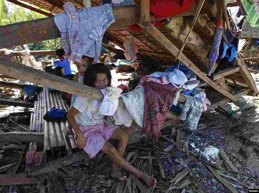 Typhoon victims stay in their house destroyed by Typhoon Hagupit in Can-avid, Samar in central Philippines, Dec. 8, 2014.
