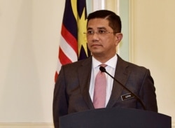 FILE - Malaysia's Minister of Economic Affairs Azmin Ali gives a news conference after a High-Speed Rail (HSR) signing ceremony at Putrajaya, Sept. 5, 2018.