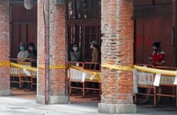 People wear face masks to help protect against the spread of the coronavirus as they line up at a rapid Covid testing center after the COVID-19 alert rose to level 3 in Taipei, Taiwan, May 18, 2021.