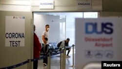 FILE - Travelers line up at the new Corona Test Center at Duesseldorf Airport in Duesseldorf, Germany.