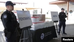 FILE - Packets of fentanyl mostly in powder form and methamphetamine, which U.S. Customs and Border Protection say it seized from a truck crossing into Arizona from Mexico, is on display during a news conference at the Port of Nogales, Arizona, Jan. 31, 2019.